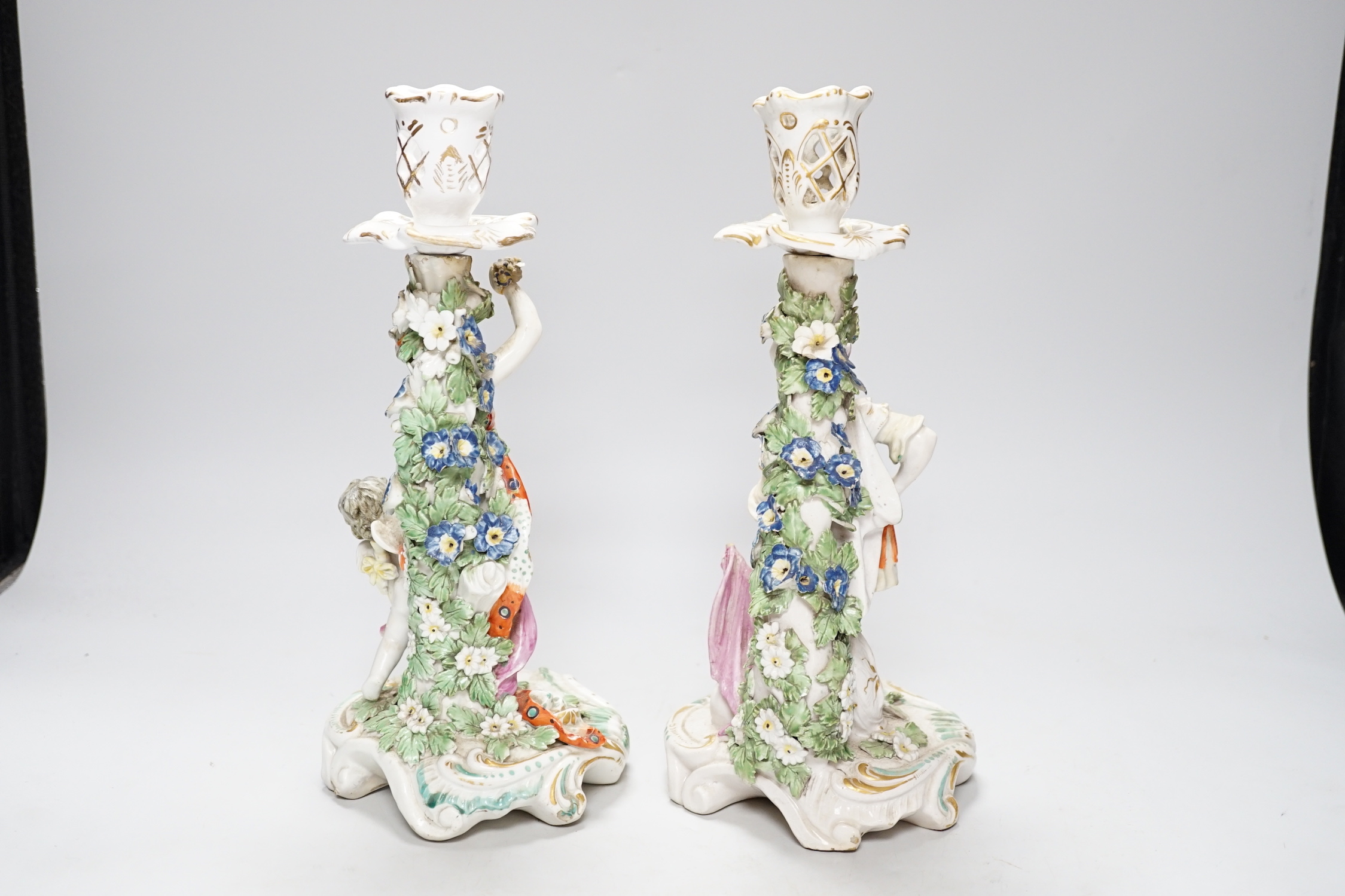 A pair of 18th century Derby figural candlesticks, 29cm